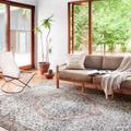 Wynter rug shown in a bright, modern living room with sofa and chair on light wood floor