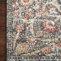 Corner detail showing color variation and intricate patterned border of Saban Blue Spice rug laid on wood floor