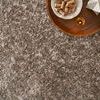 Close-up of rug in room setting with wooden tray holding wine corks and glass on top