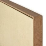 Close-up of top corner showing raw canvas stretched tightly and smooth vertical grain white oak frame finish