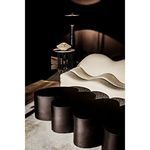 Moray Floor Lamp in modern room setting with sculptural sofa and round black furniture pieces