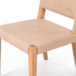 Close-up view of Villa Dining Chair seat and backrest junction showing leather texture and wood details