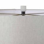 Close-up of white linen drum lamp shade texture and top finial