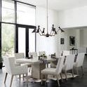 Line dining room from side with Linea chairs around concrete table and black and brass pendant light