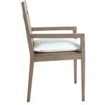 Side view of Savannah Arm Chair with white seat cushion showing slender armrest and woven raffia panels
