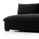 Low side angle close-up showing sofa's plush cushions and block feet on white background