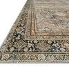 angled close-up of rug’s layered floral border edge with cream and charcoal colors