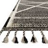 Close-up view of the rug’s edge showcasing the playful multicolored beige and charcoal fringe tassels