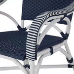 Close-up side view of chair showing striped armrest wrapping and woven navy seat detail