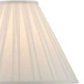 Close-up of ivory textured faux leather on the hexagonal lamp base with brass detailing