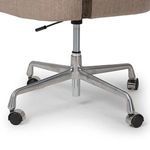 Close-up of Henrik Desk Chair's polished metal base with casters and seat height adjustment lever