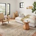 Rug styled in a bright living room with neutral furniture and natural decor, showing overall scale and room integration