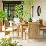 Outdoor dining setup with multiple Savannah Teak Arm Chairs around a teak table on tiled patio