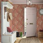 Entryway featuring Alyworth Trail wallpaper covering all walls, styled with boots, hats, and a wall clock