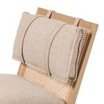 Close-up of Kenzo Chair back cushion attached with fabric straps over cane webbed back