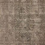 Close-up of central medallion and intricate vintage floral design with textured jute weave