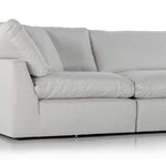 Side-angle close-up showing armrest and detailed stitching on plush cushions