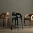 Three bar stools in a row, including Hawkins stool in butterscotch and black leather finishes