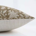 Side view showing natural linen texture on pillow back and detailed floral pattern on front