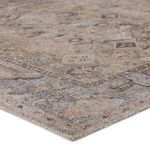 Close-up of rug corner highlighting low-pile texture and subtle color blending of green and blue