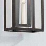 Close-up of textured black metal frame and clear glass panels of Amire wall sconce