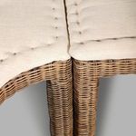 Close-up on left banquette armrest showing woven texture and beige cushion seam