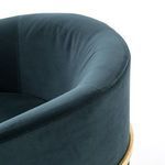 Detailed shot showing brass frame line beneath velvet armrest on Corbin Chair