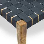 Close-up of seat corner showing woven black webbing and rich oak wood grain texture