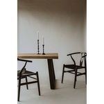 Two Ventana chairs next to rectangular wooden table with tapered black legs against neutral background