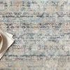 Close-up of rug's mix of abstract and traditional motifs with slight pile texture and a bowl of peaches on top