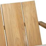 Close-up of vertical teak wood slats with a warm natural finish and wood grain variation
