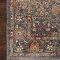Corner close-up of Giada Rug showing detailed border design and fringe on wood floor background