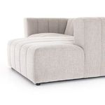 Detail of inside corner between sectional’s back and seat cushions with vertical channeling