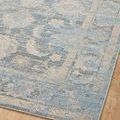 Close-up on rug surface showing subtle floral and vine patterns with slight color variation