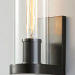 Close-up showing textured knurled lamp socket and metal backplate in old bronze finish
