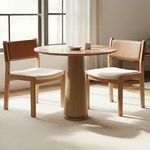 Carol Dining Chair Set of Two styled around a round wood dining table in sunlit room