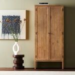Knightdale Brown Wooden Cabinet styled in room with green wall, modern art, and minimalist white vase on wood stool