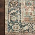 Corner close-up of Margot Terracotta Lagoon Rug showing detailed floral border and contrast between rug and dark wood floor