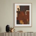 Framed abstract painting hanging on wall above wooden mantel with decorative vases, plant, and books