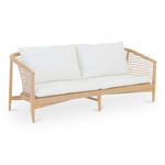 Kuna Outdoor Sofa angled view showing tapered wooden legs and curved woven armrests