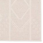 Close-up of cream rug's raised medallion detail and vertical line texture