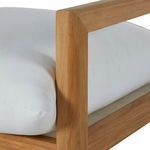 Close-up of wooden armrest corner and white fabric cushion