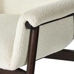 Armrest detail showing fabric wrapping over rounded wood and upholstery seams