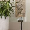 Close-up of Kiran Gunmetal Picture Frame styled indoors with a floral sketch inside and a plant in white pot nearby