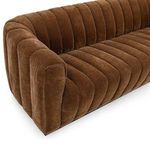 Angled view focusing on seat cushions with visible channel design and plush velvet upholstery