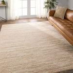 Rug placed in room scene featuring wooden floor and tufted caramel leather sofa