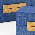 Detailed close-up showing gold leaf ribbed hardware on blue raffia box