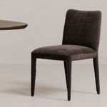 Calla dining chair in dark grey near wooden table showcasing material texture and room context