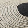 Close-up of the textured concentric circle embroidery showing detailed stitching and fabric weave