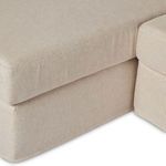 Close-up of slipcover fabric and stitching at sectional chaise base